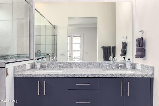 bathroom with vanity and a shower with shower door