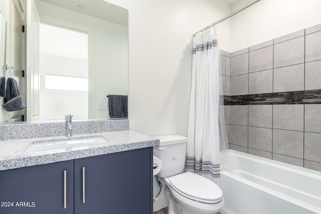 full bathroom with shower / bath combo, vanity, and toilet