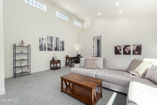 living room with carpet and a towering ceiling