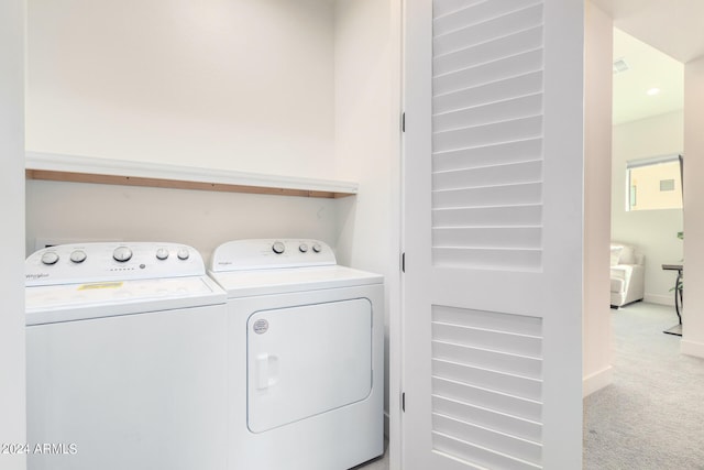 washroom with light colored carpet and separate washer and dryer