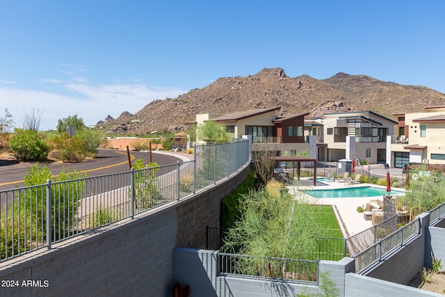 view of pool featuring a mountain view and a patio