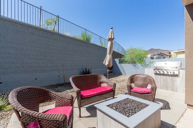 view of patio with grilling area and an outdoor fire pit