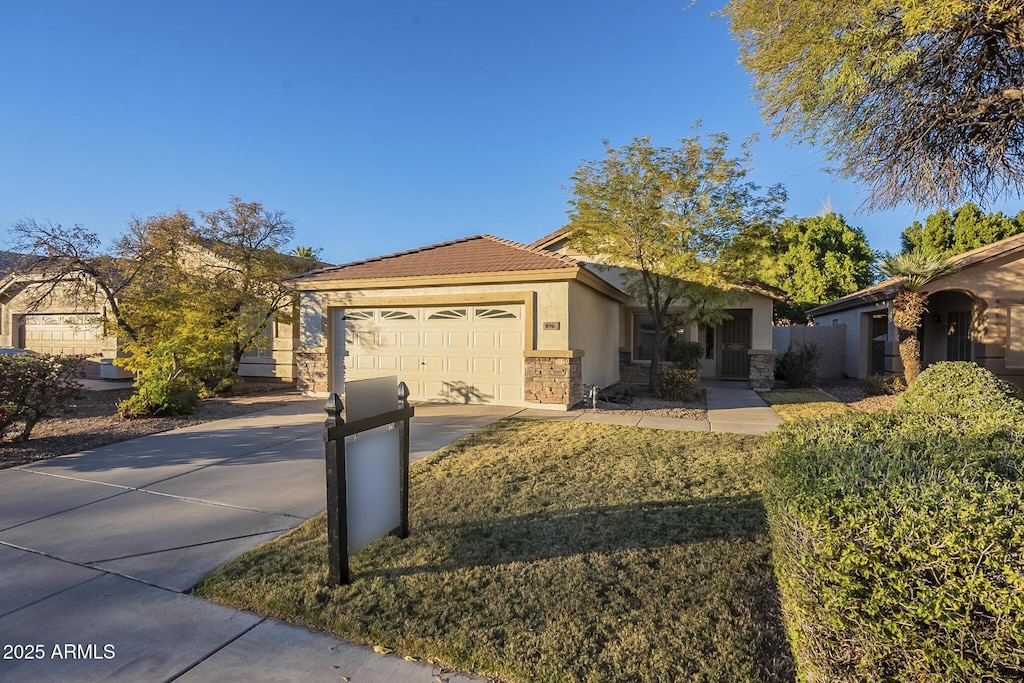 ranch-style home featuring a front lawn and a garage