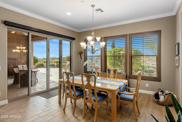 dining room with light wood-type flooring, visible vents, a notable chandelier, and crown molding