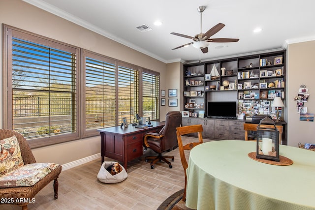 office featuring visible vents, ceiling fan, crown molding, and light wood finished floors