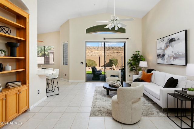 tiled living room featuring ceiling fan, lofted ceiling, and a healthy amount of sunlight