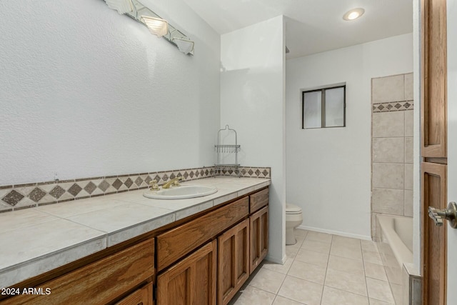 bathroom featuring tile patterned flooring, vanity, and toilet