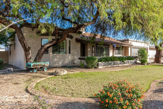 view of front of house with a front yard and a garage