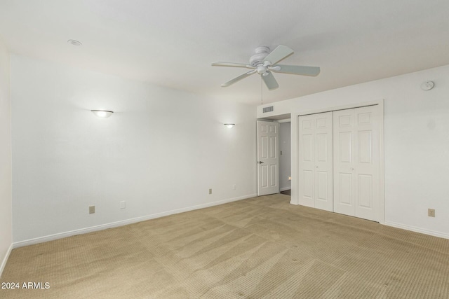 unfurnished bedroom with ceiling fan and light carpet