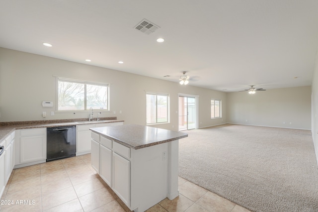 kitchen with sink, dishwasher, a center island, white cabinets, and light colored carpet