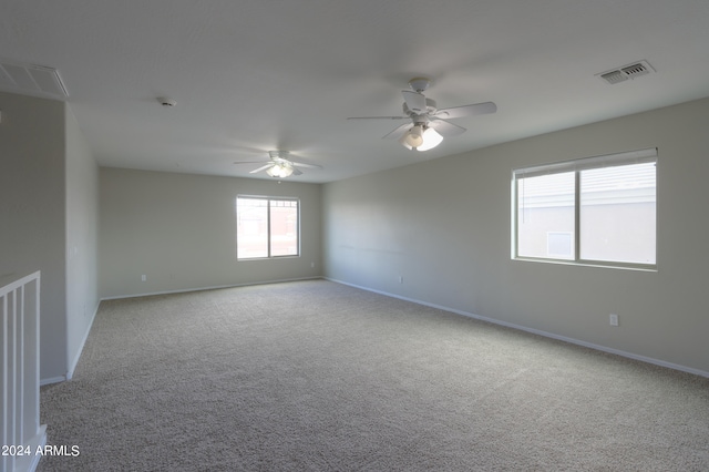 carpeted empty room featuring ceiling fan