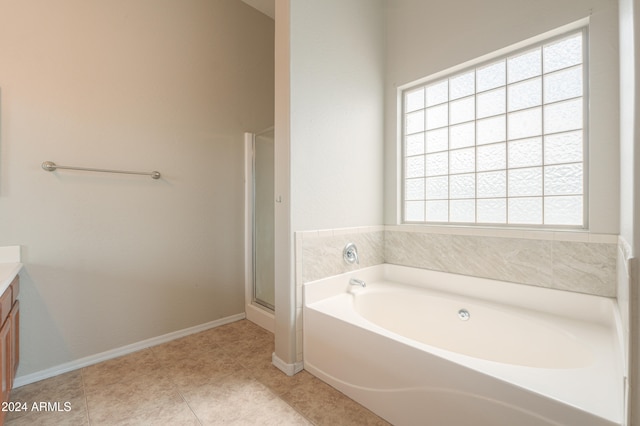 bathroom with vanity, tile patterned floors, and plus walk in shower