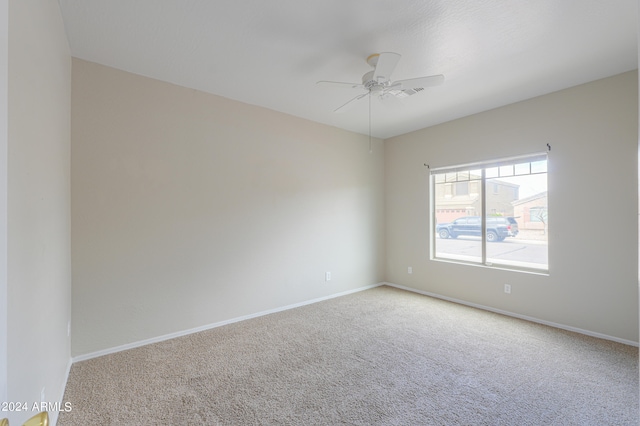 spare room featuring carpet flooring and ceiling fan