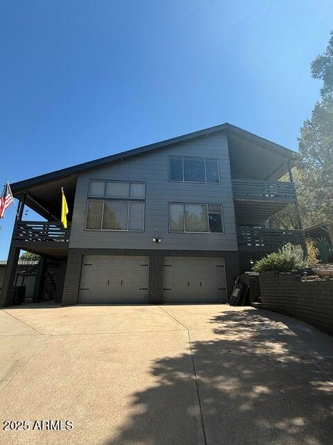 view of front of home with an attached garage and concrete driveway