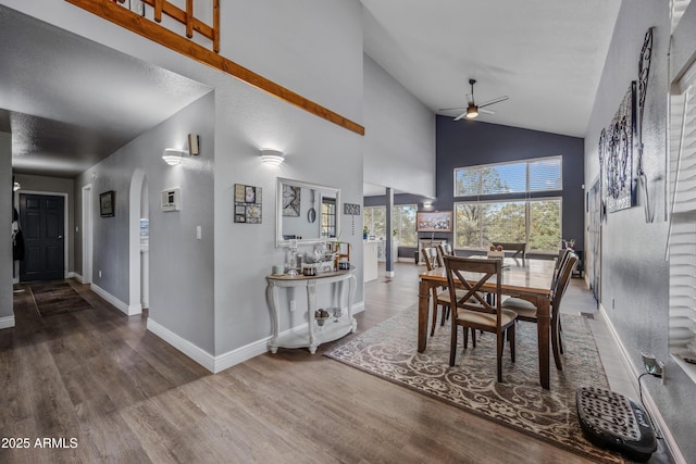 dining room with wood finished floors, baseboards, and a ceiling fan