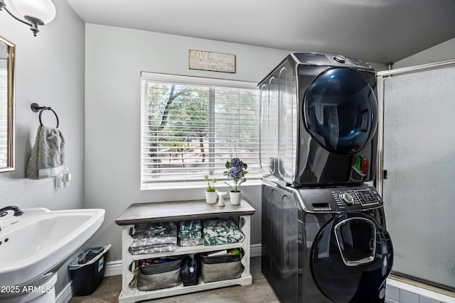 laundry area with stacked washer / dryer and laundry area