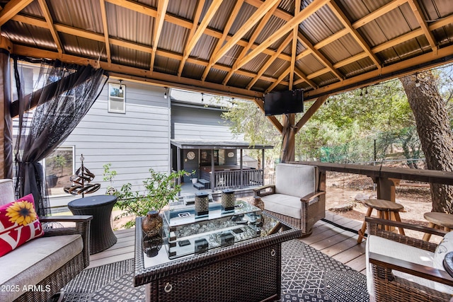 wooden terrace with a gazebo and an outdoor hangout area