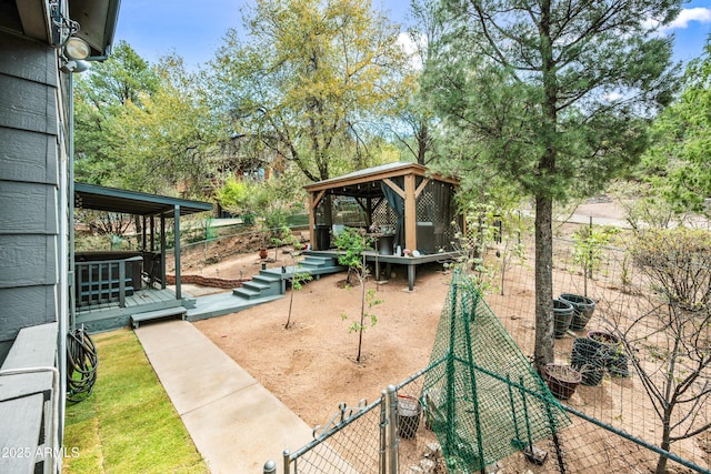 view of yard featuring a gazebo, fence, a gate, and a wooden deck