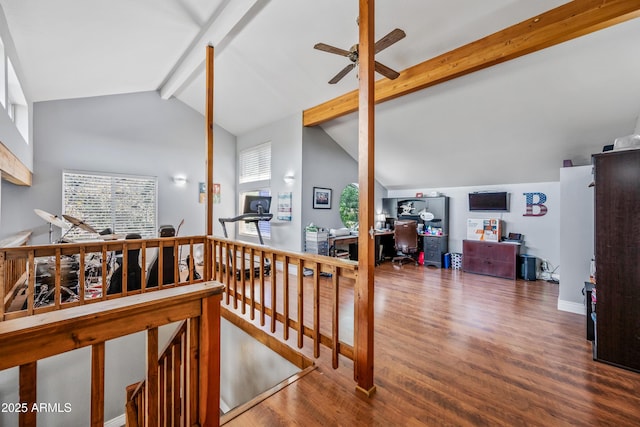 stairway featuring ceiling fan, wood finished floors, and lofted ceiling with beams