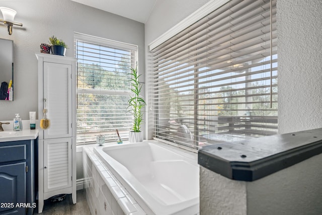 bathroom featuring vanity and a garden tub