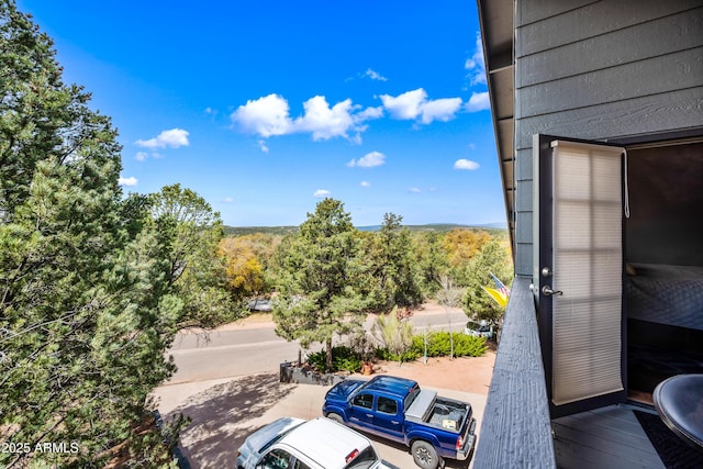 exterior space featuring a wooded view