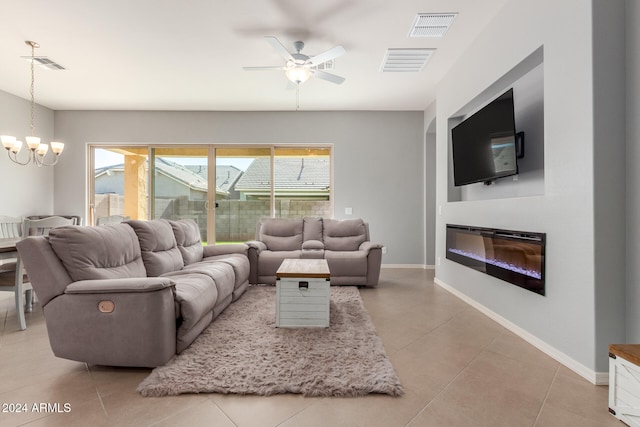 tiled living room featuring ceiling fan with notable chandelier