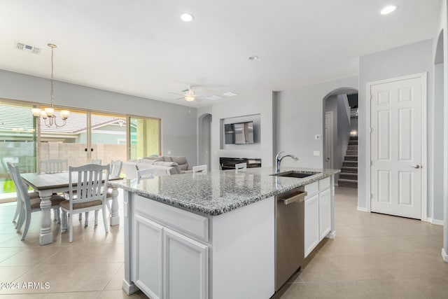 kitchen featuring a center island with sink, sink, white cabinetry, ceiling fan with notable chandelier, and pendant lighting