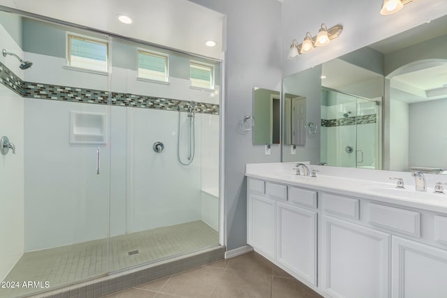 bathroom featuring an enclosed shower, vanity, and tile patterned floors