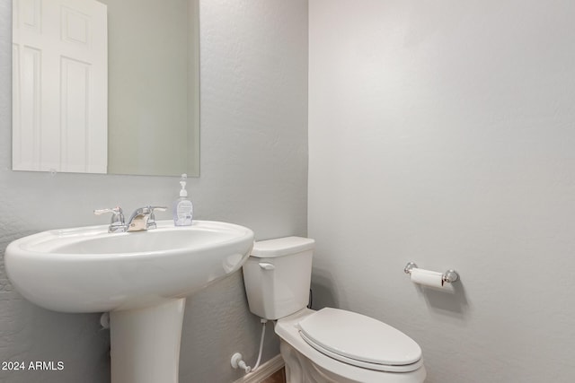 bathroom featuring sink and toilet