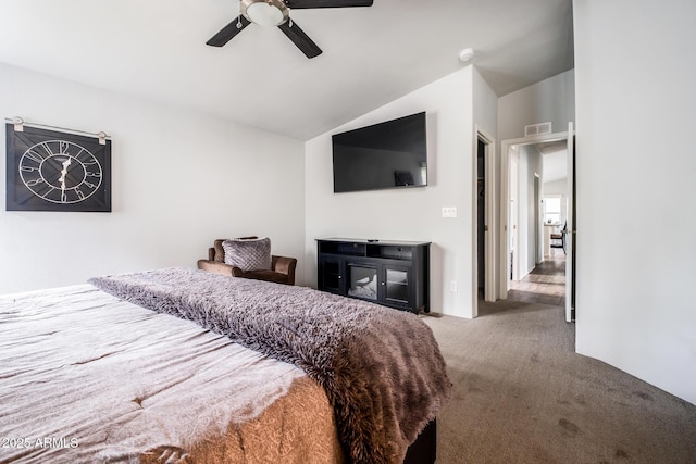 carpeted bedroom featuring visible vents, a ceiling fan, and vaulted ceiling