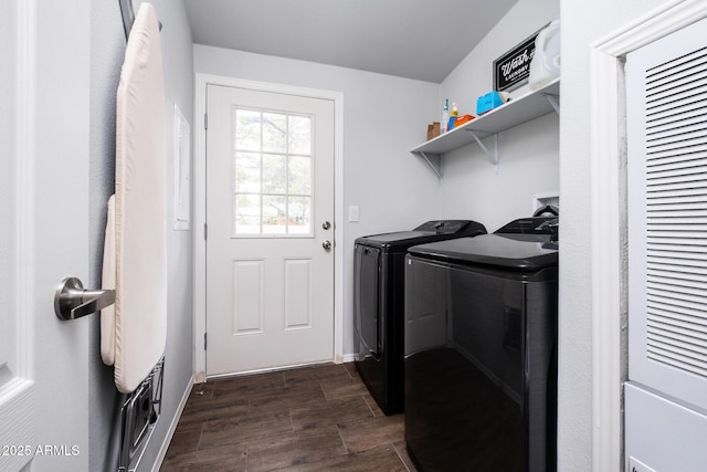 laundry room featuring washer and dryer, baseboards, dark wood-type flooring, and laundry area