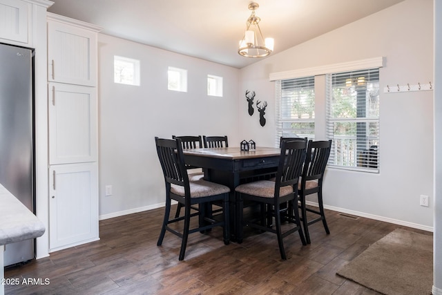 dining area featuring visible vents, baseboards, a chandelier, vaulted ceiling, and dark wood-style floors