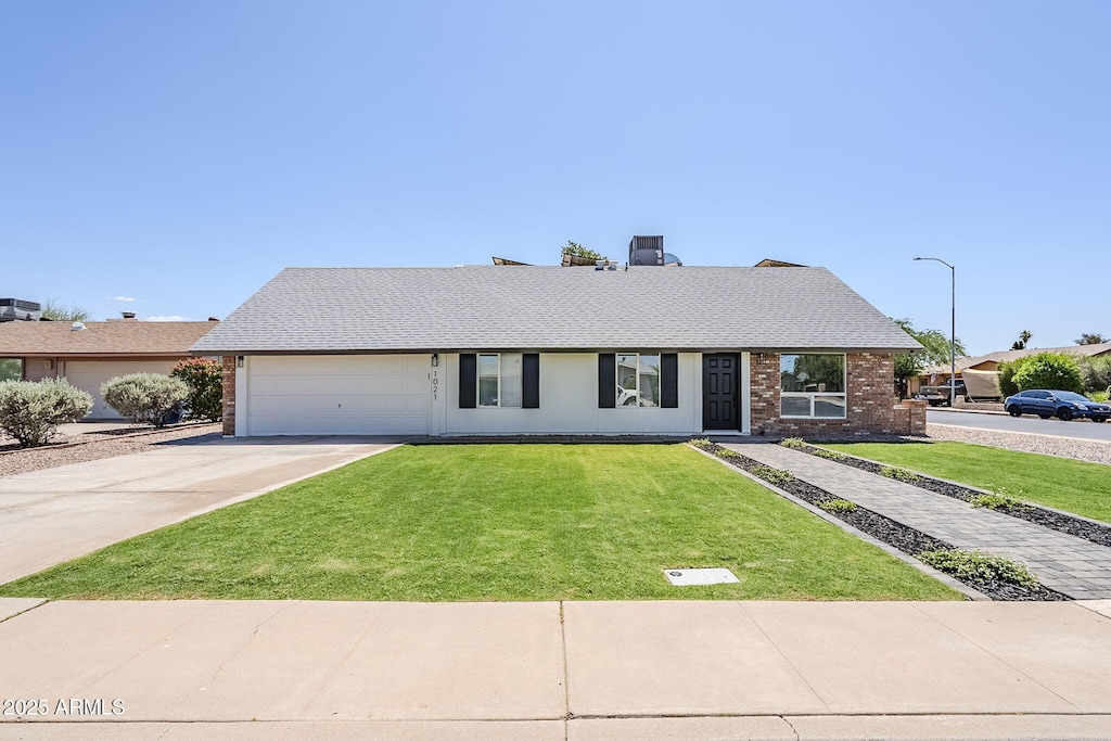 1021 S Almar Cir, Mesa, AZ 85204 - view of front of property featuring concrete driveway, a garage, a front lawn, brick siding, and roof with shingles