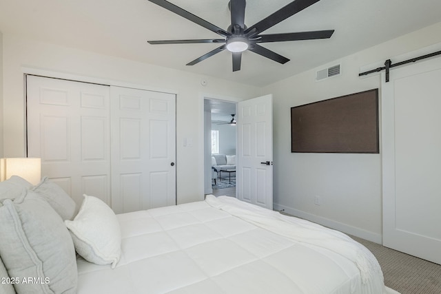 1021 S Almar Cir, Mesa, AZ 85204 - bedroom featuring a barn door, a closet, carpet, a ceiling fan, and baseboards
