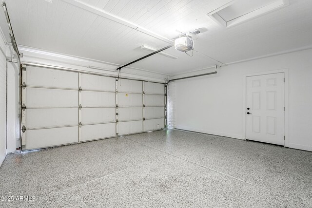 1021 S Almar Cir, Mesa, AZ 85204 - garage featuring a garage door opener and baseboards