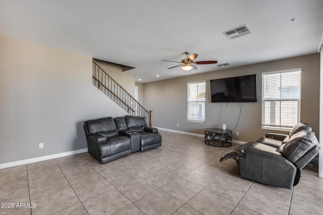 living area with visible vents, a healthy amount of sunlight, and ceiling fan