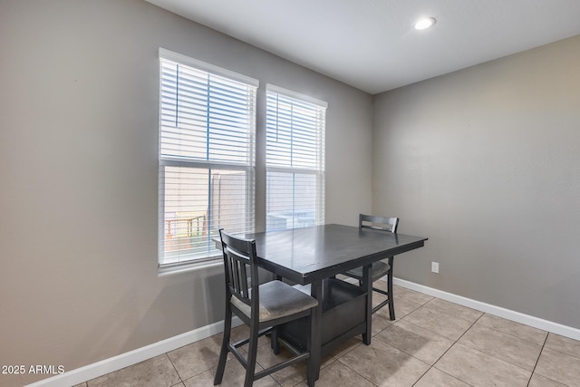 dining space with light tile patterned floors and baseboards