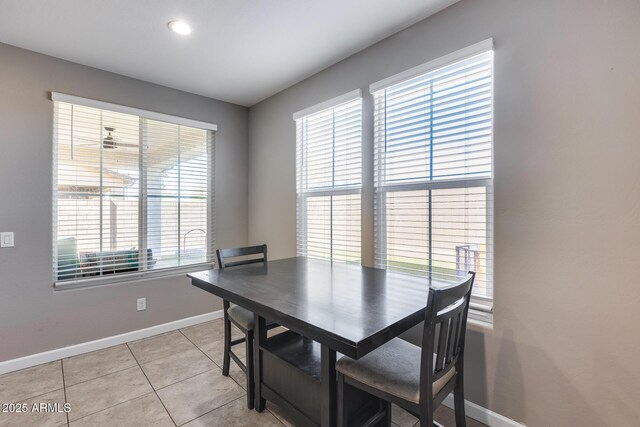 dining space with light tile patterned flooring and baseboards