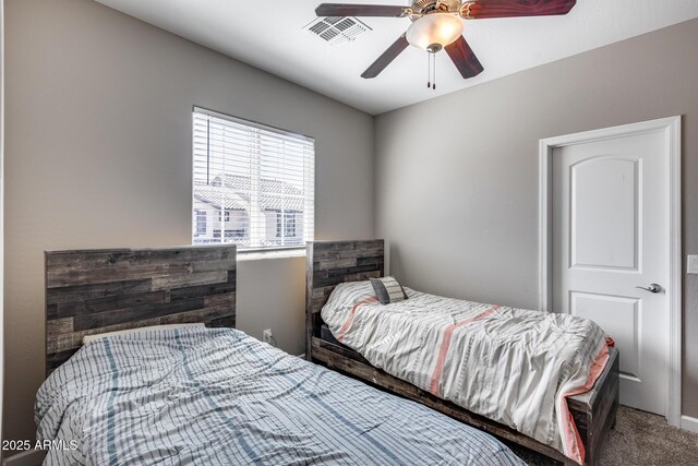 carpeted bedroom featuring visible vents and ceiling fan