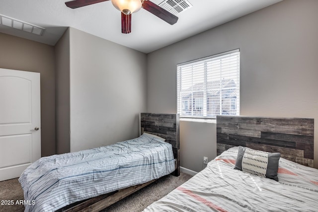 carpeted bedroom featuring visible vents, baseboards, and a ceiling fan