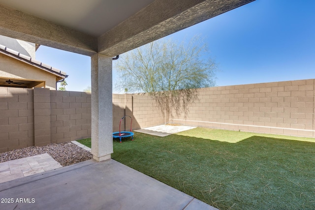 view of yard featuring a fenced backyard, a patio area, and a trampoline