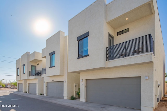 view of front of home with a balcony and a garage