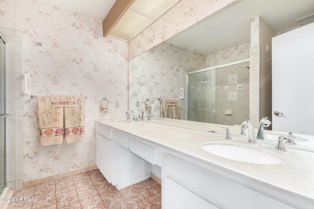 bathroom featuring tile patterned flooring, vanity, and a shower with door