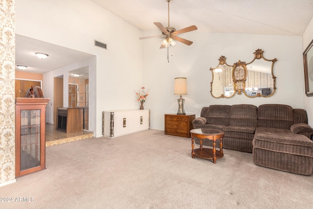 carpeted living room featuring ceiling fan and high vaulted ceiling