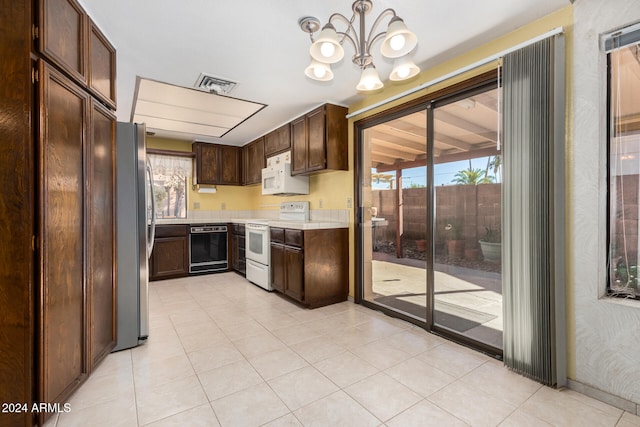 kitchen featuring pendant lighting, white appliances, an inviting chandelier, and dark brown cabinetry