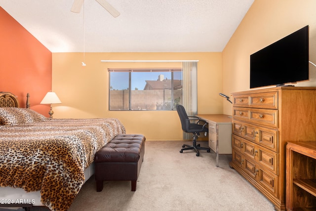 carpeted bedroom with ceiling fan and vaulted ceiling