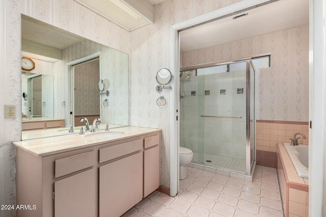 full bathroom with tile patterned floors, vanity, separate shower and tub, and toilet