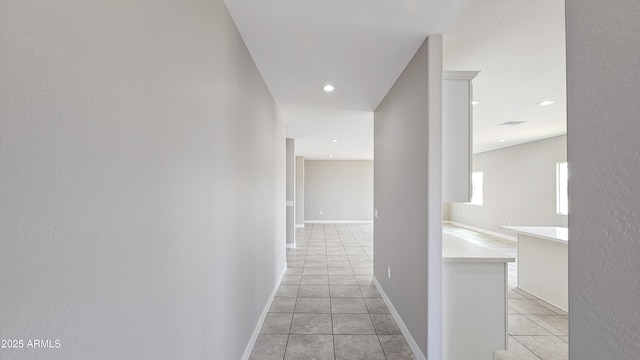 hallway with light tile patterned flooring and recessed lighting