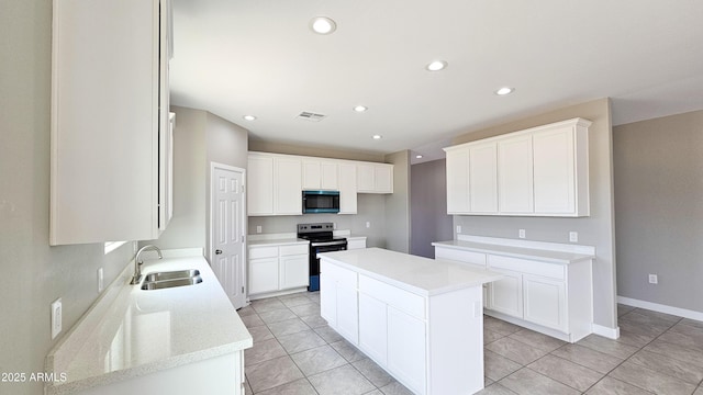 kitchen featuring stainless steel electric range, a sink, a center island, recessed lighting, and light tile patterned floors