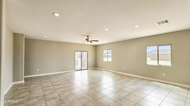unfurnished room with a ceiling fan, recessed lighting, light tile patterned floors, and baseboards